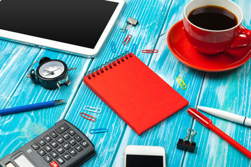 Modern workplace with cup of coffee on wooden table