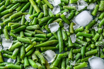 Frozen green beans with ice cubes, closeup