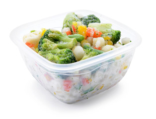 Plastic container with frozen vegetables on white background