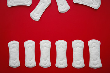 Menstrual pads on color background, top view