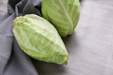 Fresh pointed cabbages on grey table