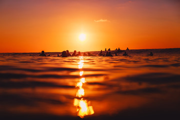 Surfers on line up at sunset. Professional surfing in ocean, Bingin beach