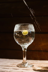 Champagne is poured into a glass, at the bottom of which is an olive