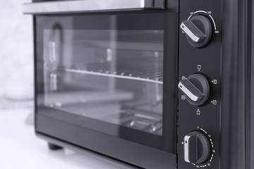 Modern electric oven on white table  in kitchen