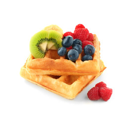 Tasty waffles with fruits and berries on white background