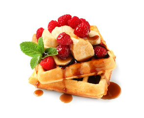 Tasty waffles with fruit, berries and chocolate topping on white background