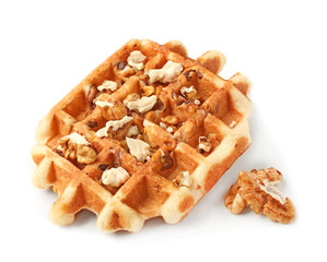 Tasty waffle with nuts on white background