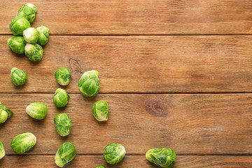 Fresh brussels sprouts on wooden background, top view