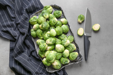 Plate with fresh brussels sprouts on table, top view