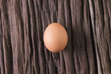  raw chicken eggs on old brown wooden