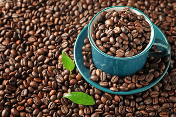 Cup on roasted coffee beans