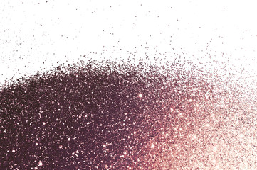 Brown glitter sparkles on white background. Beautiful abstract backdrop