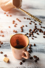 Empty cup after drinking of tasty coffee on wooden table