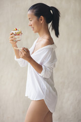 Healthy asia woman smile black hair white shirt with mix fruits yogurt