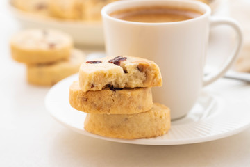 A cup of coffee with homemade cookies on a white background.
