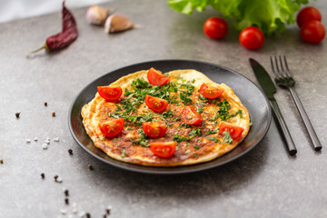 Omelet with tomatoes and herbs. Delicious breakfast