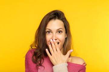 surprised shocked astonished amazed girl covering mouth with hand. unbelievable news. young...