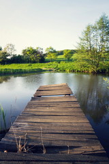 Pretty wooden pier at pond during sunset, colorful summer day, new life change concept, fresh start, new year resolution, dieting and healthy lifestyle