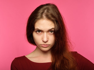 stern piercing look. portrait of a young serious fierce woman. emotional facial expression....