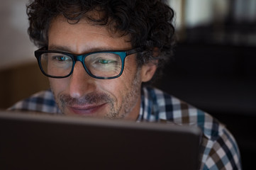 Man working on tablet at night