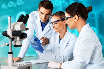 Female and male scientists in glasses working