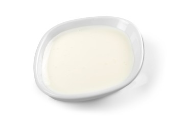sour cream in bowl, isolated on white