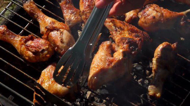 Close-up chicken legs roasted on a grill outdoors