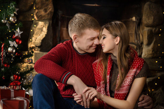young couple rest near fireplace
