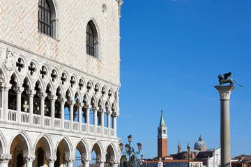 Fototapeta na wymiar Venice, Doge palace and San Marco lion statue on column in a sunny day in Italy