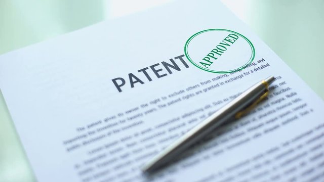 Patent document approved, hand stamping seal on official paper, copyright law