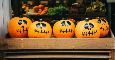 Halloween pumpkin on wooden background. Food market in Barcelona during the Holidays.