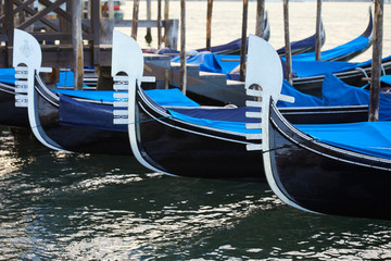 Fototapeta na wymiar Gondola boats moored in Grand Canal in the early morning in Venice, Italy