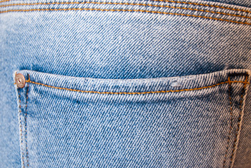 pocket on blue jeans worn by a girl