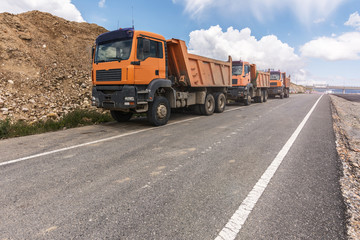 Trucks working on the construction of a road