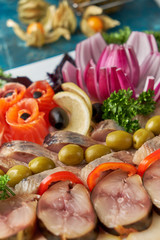 Plate with fish platter on blue background