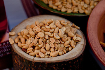 Peeled pickled peanuts in a wooden pot on the Cossack table