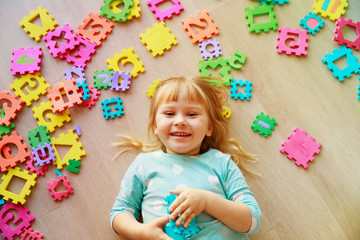 little girl playing with puzzle, early education