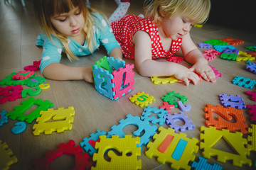 kids playing with puzzle, learning shapes and numbers