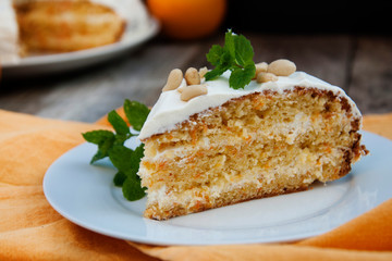 Orange and carrotn cake, wooden background. Rustic style.