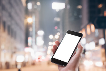 Close up Woman hand Using a Smart Phone with blank screen at night market.