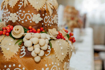 Bread, decorated with flowers and grapes from the dough. Pastry for solemn events