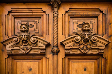details of ornate wooden door with carvings in Valencia, Spain