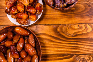 Date fruits on a wooden table. Top view