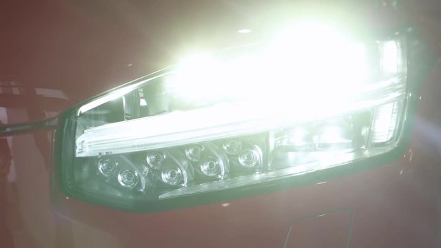 Modern car, view of exterior, lighting car headlights, camera movement.