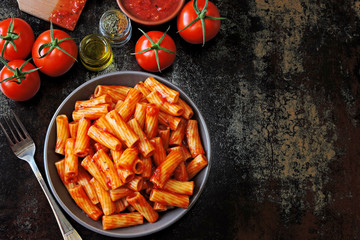 Appetizing Italian pasta with tomato sauce and spices. Pasta with tomato sauce in a bowl. Vegan lunch.