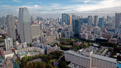 Sky view of downtown Tokyo taken from the Sky view tower. The metropolis of Tokyo expands to the horizon with the skyscrapers and towers in the foreground.