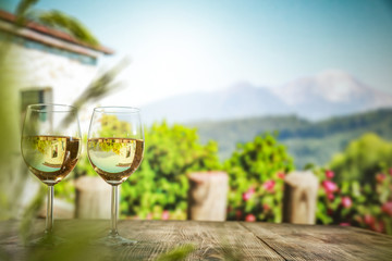 two single glasses of wine wiht free space for your bottle and blurred background. 