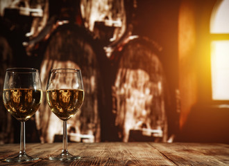 two single glasses of wine wiht free space for your bottle and blurred background. 