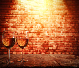 two single glasses of wine wiht free space for your bottle and blurred background. 