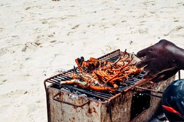 Barbecue of seafood on the beach homar langusta shrimps calmari